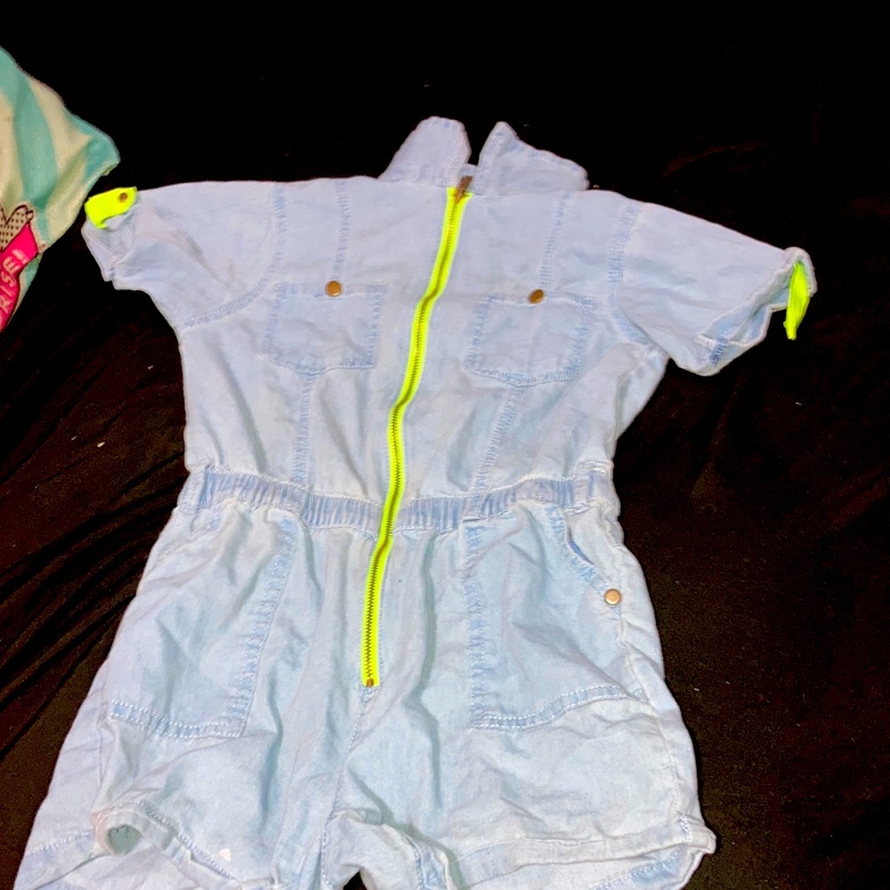 A neon blue jean romper/jumpsuit